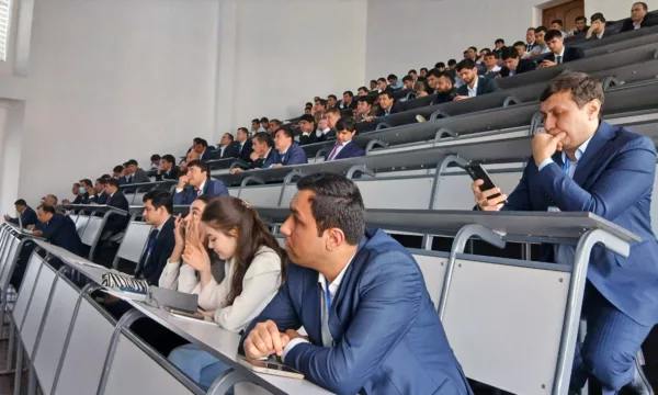 Participants in the auditorium in Tajiskitan are wearing blue suits.