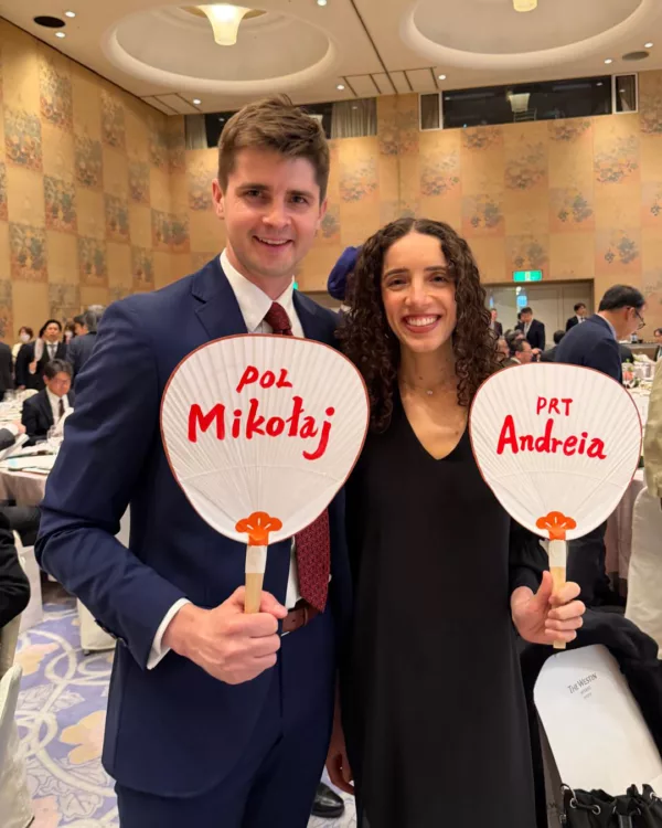 Man and woman holding up Japanese fans