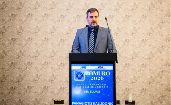 Man in a suit standing by the podium
