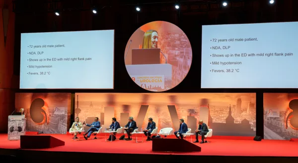 Female expert speaker on podium with a panel of male experts