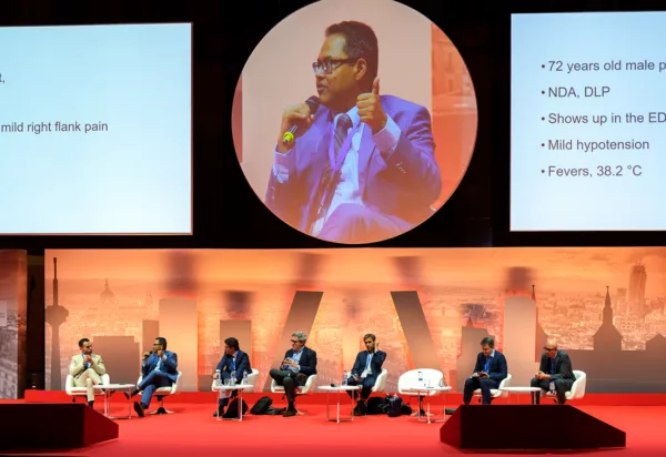Male panel member featured on the main screen while the rest of the panel members are situated below
