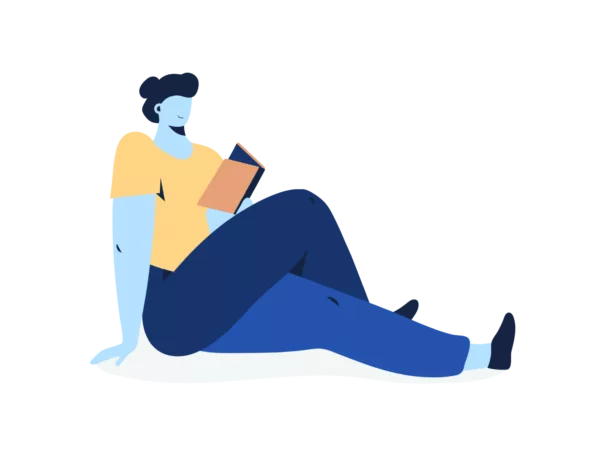 A person seated and reading a book.
