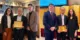 Photos of 2 men and 1 woman posing for an awarding